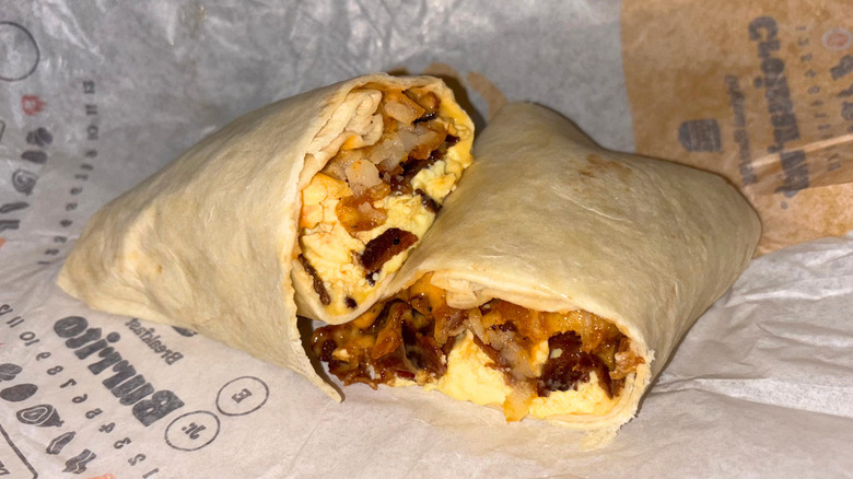 A breakfast burrito with bacon, egg, cheese, and other ingredients.