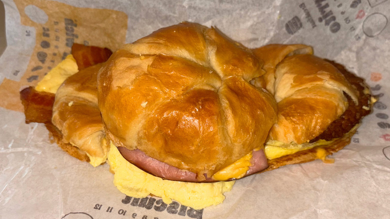 Three breakfast sandwiches stacked in a small pyramid