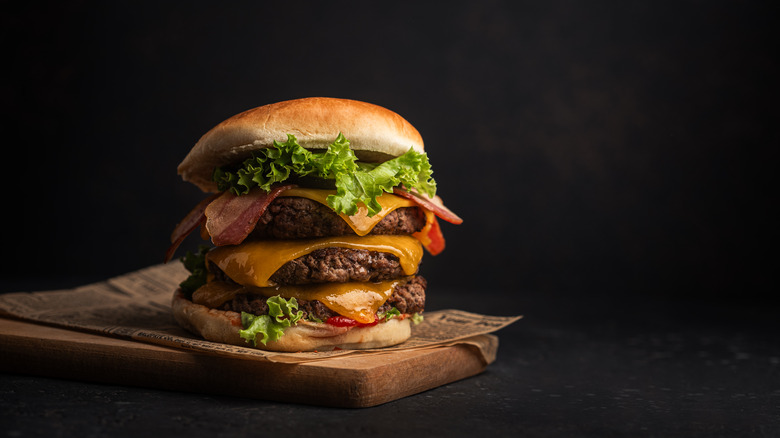 A double cheese burger with fixings