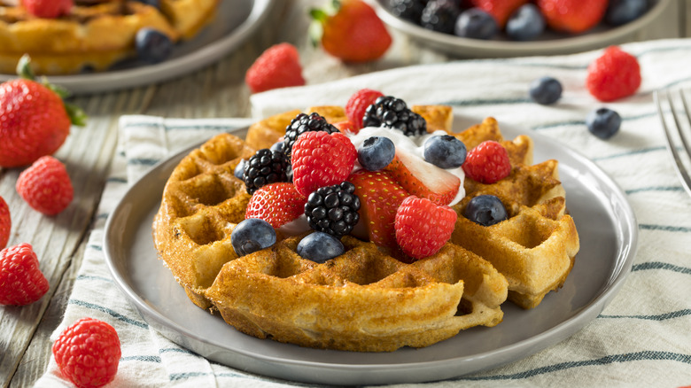 Belgian waffles with berries and whipped cream