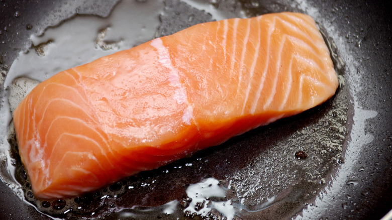 Salmon being seared in oil