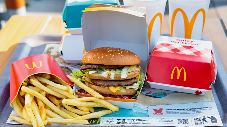 McDonald's burger, fries, Spicy McChicken box, and drinks on a tray