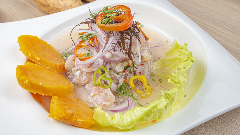 A ceviche with mango on the side in a bowl