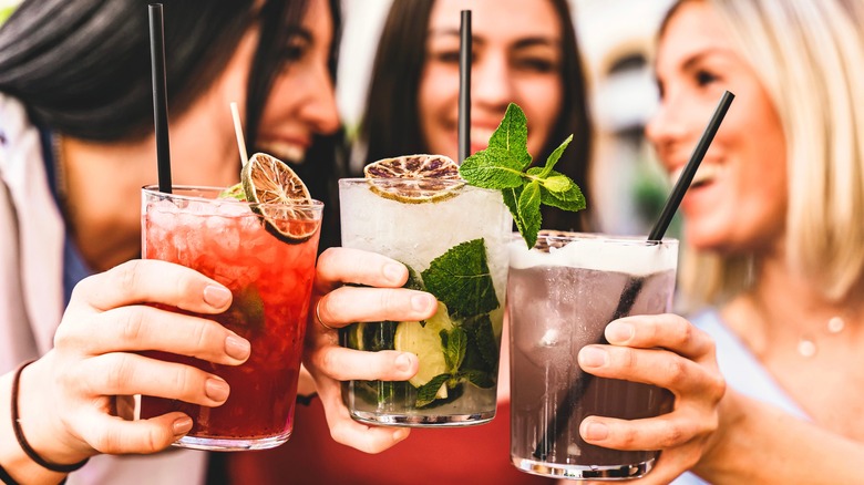 Three friends drinking cocktails