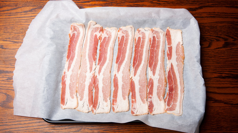 Raw bacon on parchment paper