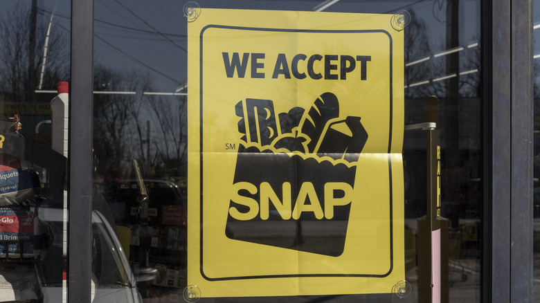 A sign in a store window reading 