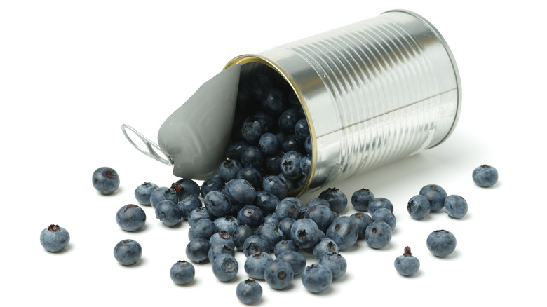 Can with blueberries spilling out