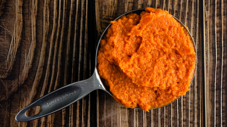 Measuring cup of pumpkin puree