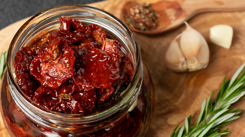 sun dried tomatoes in jar with herbs