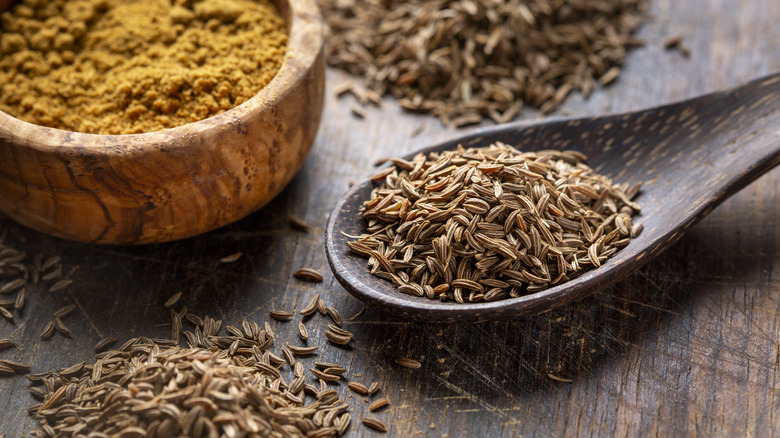 Wooden spoon with whole caraway seeds