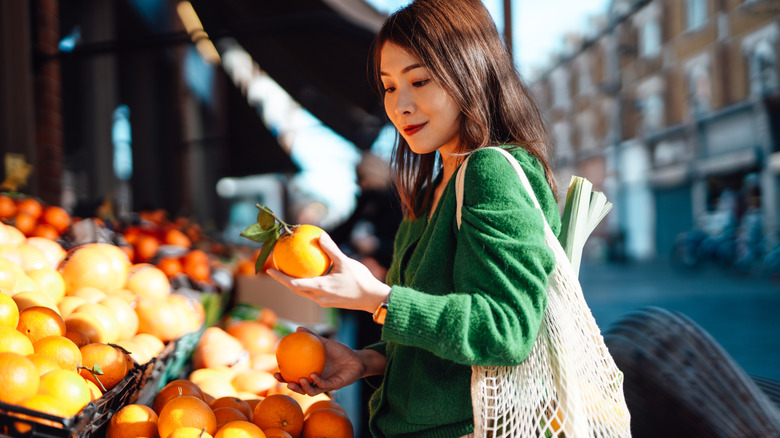 woman picking oranges