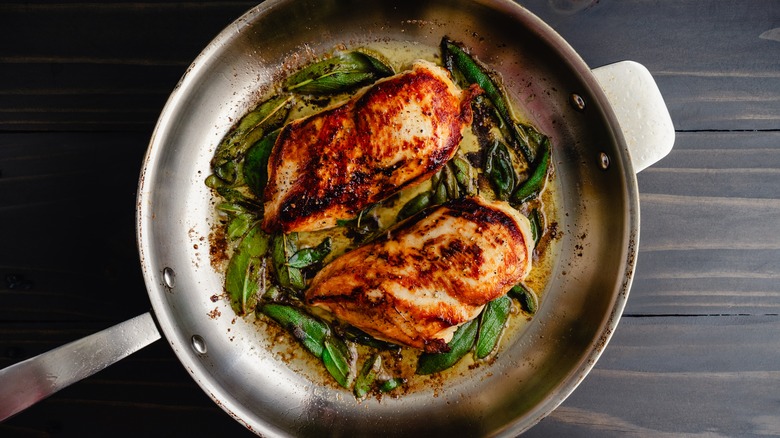 Cooked chicken in stainless skillet