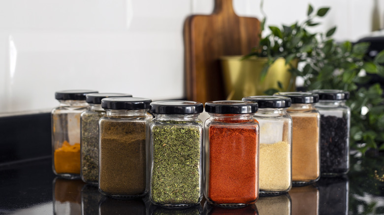 Dried herbs and spices in glass jars