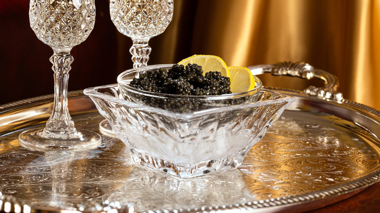 Bowl of caviar on silver platter