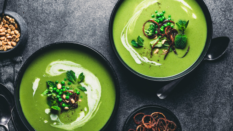 green soup in black bowls