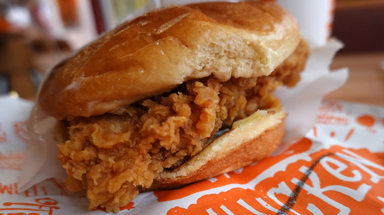 A Popeye's chicken sandwich with a bun