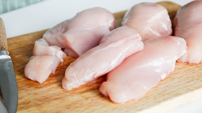 raw chicken with a knife