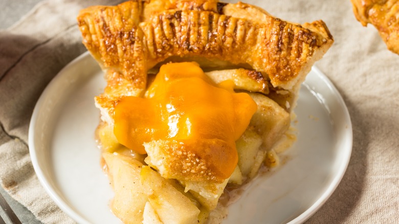 apple pie with a slice of melted cheddar cheese