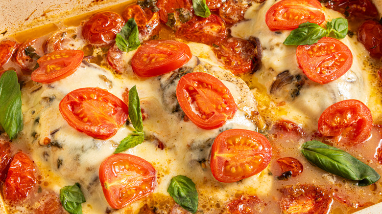 Cheesy caprese chicken bake with roasted cherry tomatoes on top