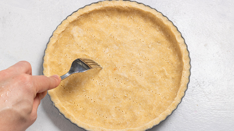 Poking a pie crust with a fork