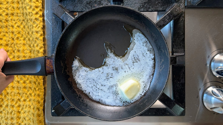 Butter melting in skillet on stovetop