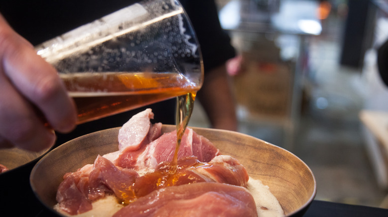 Beer poured into meat marinade