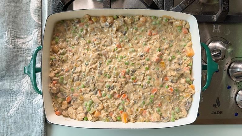 Chicken, mushroom, and winter squash pot pie filling in casserole dish on stovetop