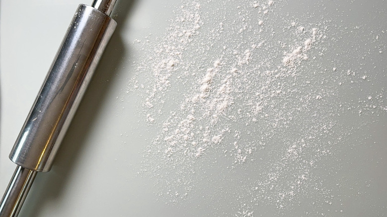 Flour and rolling pin on countertop