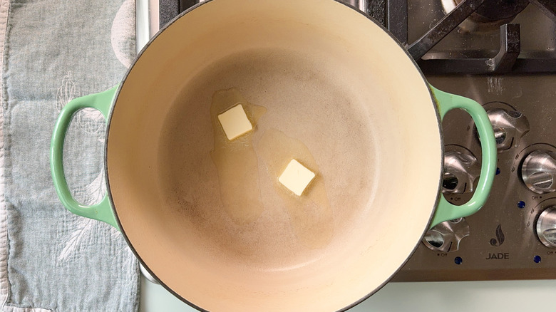 Butter melting in large Dutch oven on stovetop