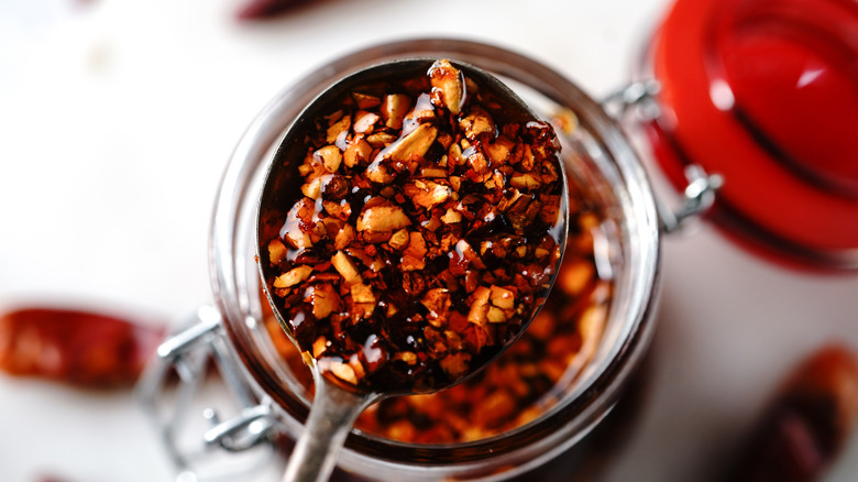A spoonful of chili crisp out of a jar
