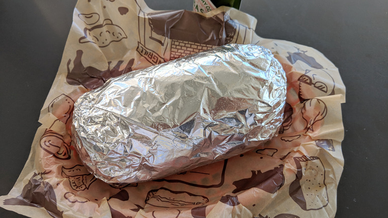 Wrapped Chipotle burrito on table