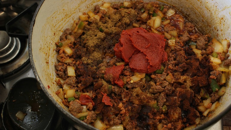 pot of meat and vegetables with spices and tomato paste