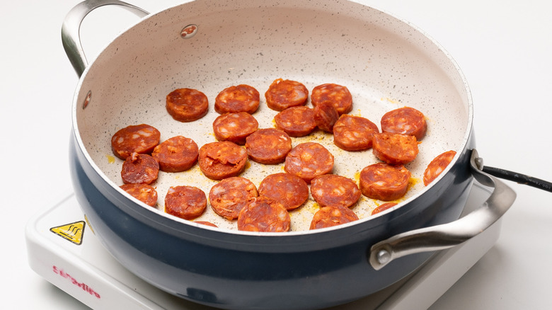 chorizo frying in a pan