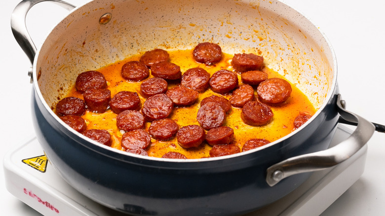 chorizo frying in a pan