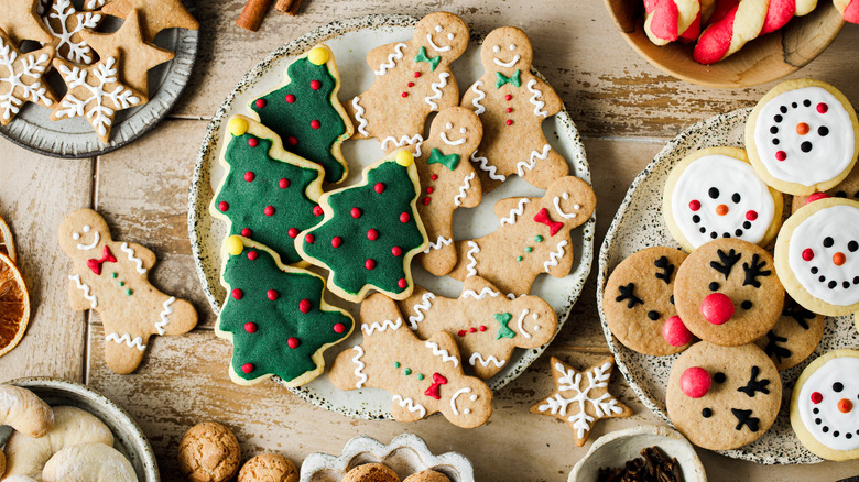 Cheerful holiday cookies arranged on plates.