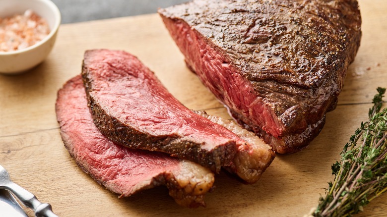 Sliced rump roast on a cutting board