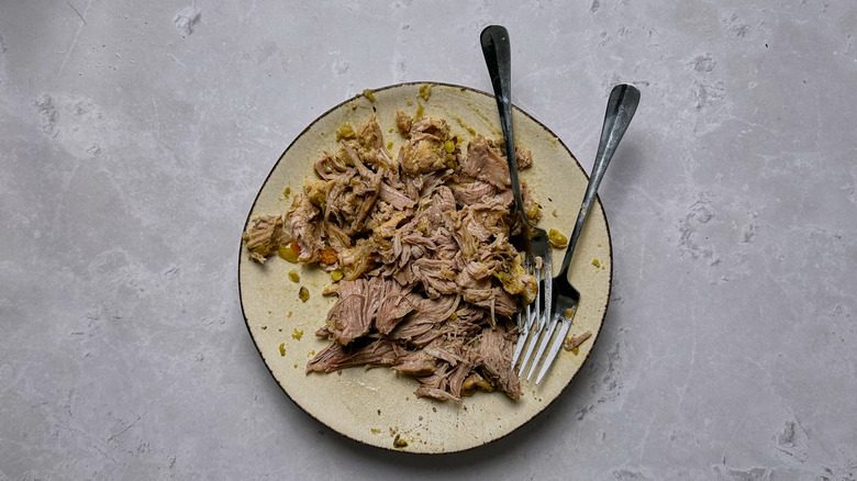 shredded pork on plate with forks