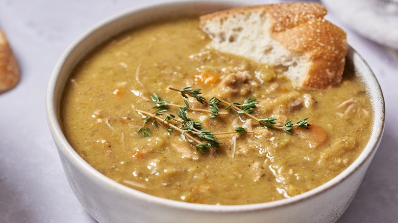 bowl of split pea soup with bread