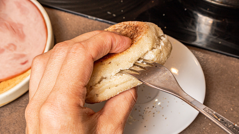 hand sticking fork into muffin