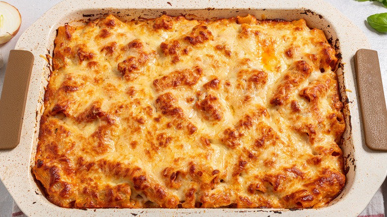 Baked pasta with melted cheese on top in a baking dish