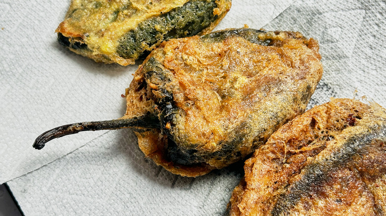 fried chiles rellenos on paper towel