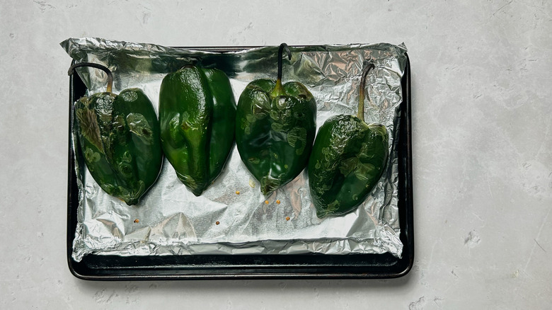 charred peppers on a sheet tray