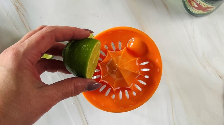 hand squeezing lime