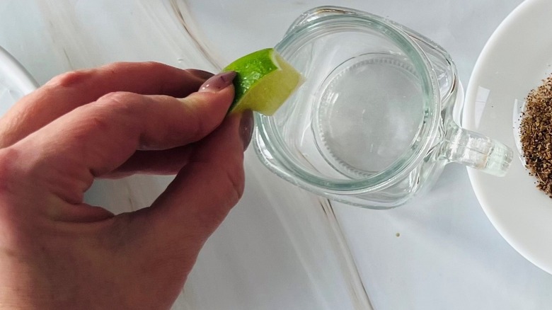 hand rubbing lime on glass