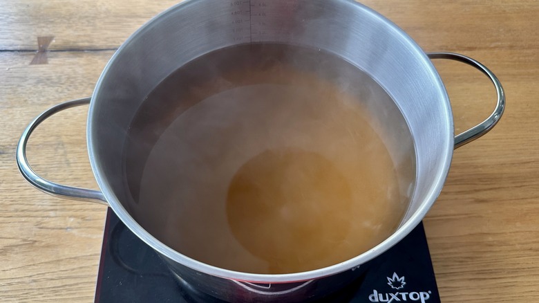 Chicken stock heating in pot