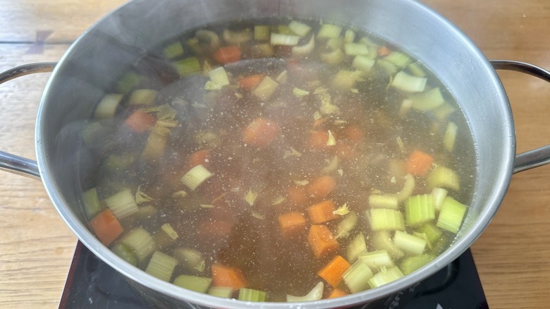 Chicken soup cooking in pot