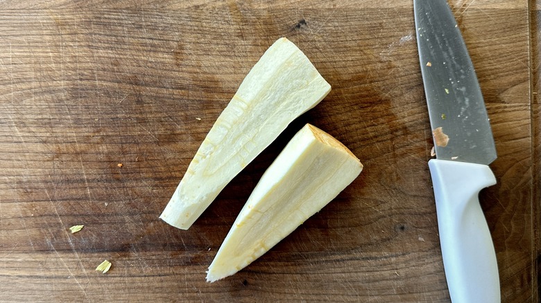 Halved parsnip on cutting board