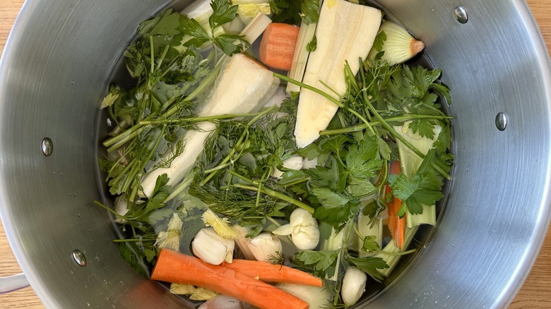 Veggies and chicken in stock pot