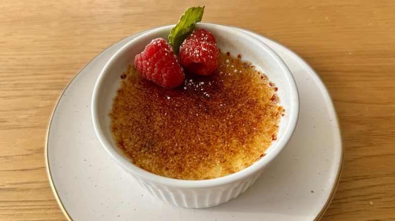 Crème brûlée garnished with raspberries