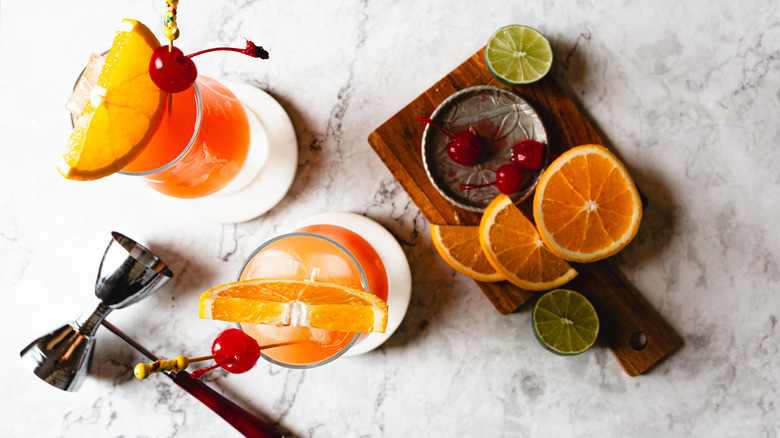 overhead view of two hurricane cocktails and garnishes